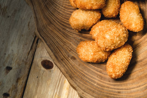 istock Chicken nuggets on a wooden board. Fast food concept 1270798875