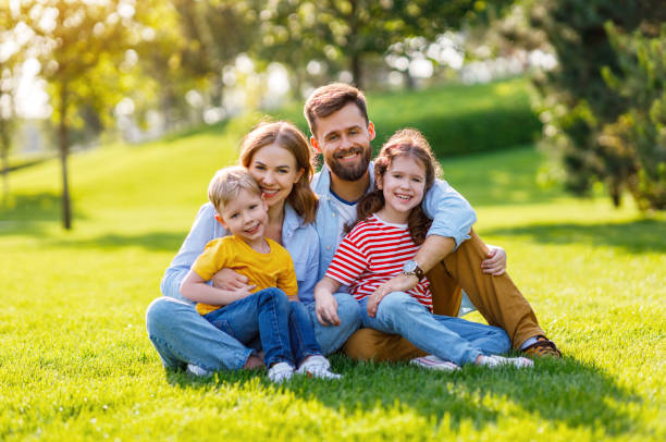 istock Delighted family hugging on lawn 1270798908