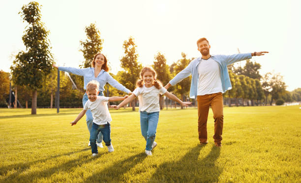 istock Happy family playing together in park 1270800288