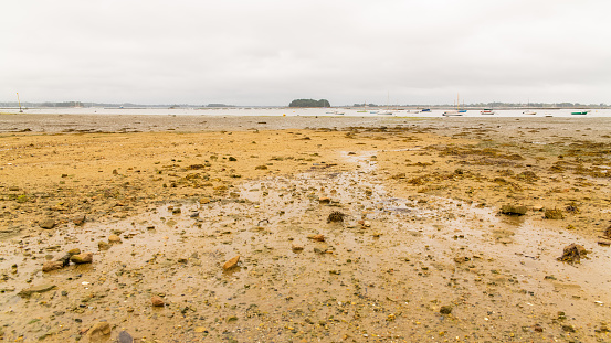 Brittany, Ile aux Moines island in the Morbihan gulf, the church and the Port-Miquel beach at low tide