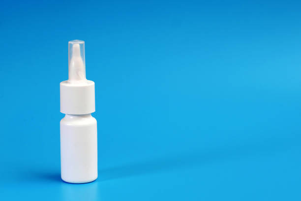 istock white nasal spray bottle on blue background with a copy space 1270801088