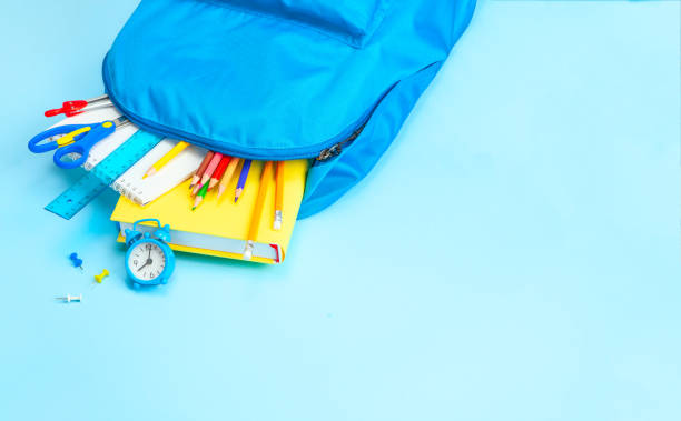 istock School bag. Backpack with supplies for school on blue background. Copy space for text 1270803485
