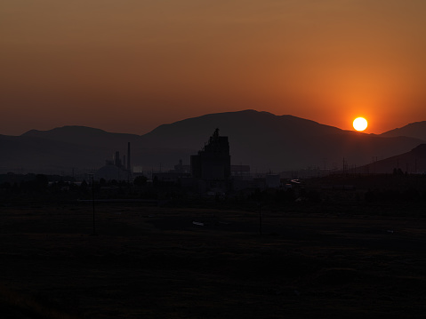 Industrial area east of Reno Nevada during a smoky smoggy sunrise.