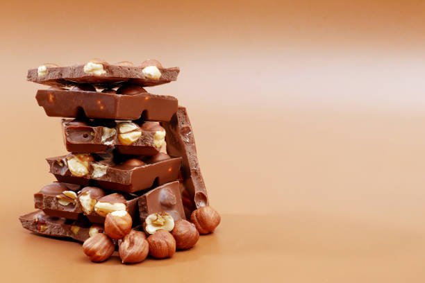 istock stack of milk chocolate pieces and hazelnuts on brown background 1270805795