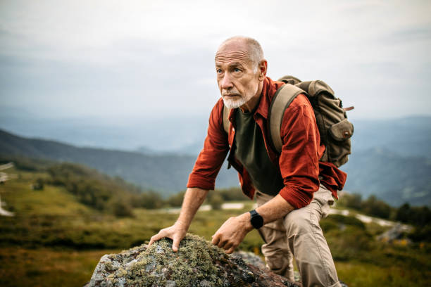 istock Senior Man Climbing on Mountain Rock 1270807839