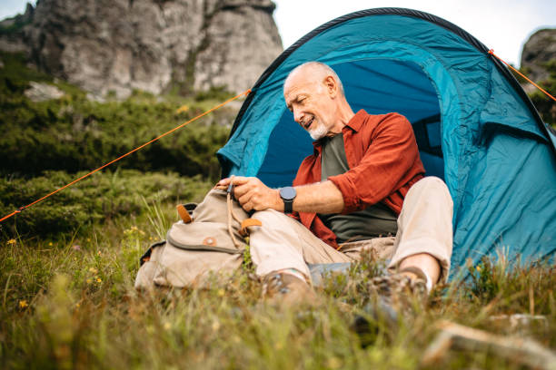 istock Senior camper preparing himself for night in tent 1270807868