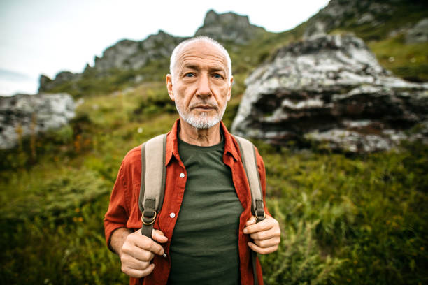istock Senior with Backpack Hiking on Autumn Day 1270808084