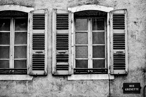 Shuttered properties on the Rue Grenette next to the canal in Annecy, France.