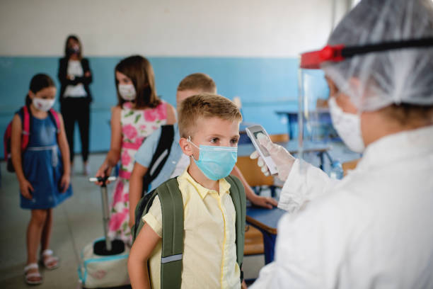 istock Pediatrician using thermometer temperature screening for school children 1270812871