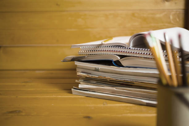 istock Stack of school books and pencil holder on desk 1270815081