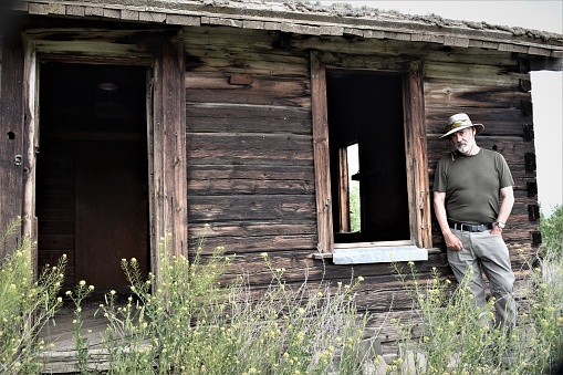 Old abandoned wooden house or barn.  Empty, broken windows.