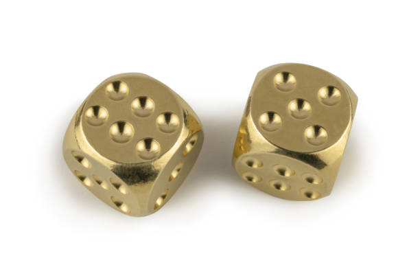 istock Two golden professional game dice closeup isolated on a white background / six and five with a light shadow. 1270820535