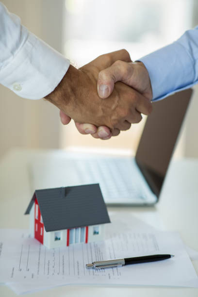 istock Real estate broker and customer shaking hands after signing a contract 1270821650