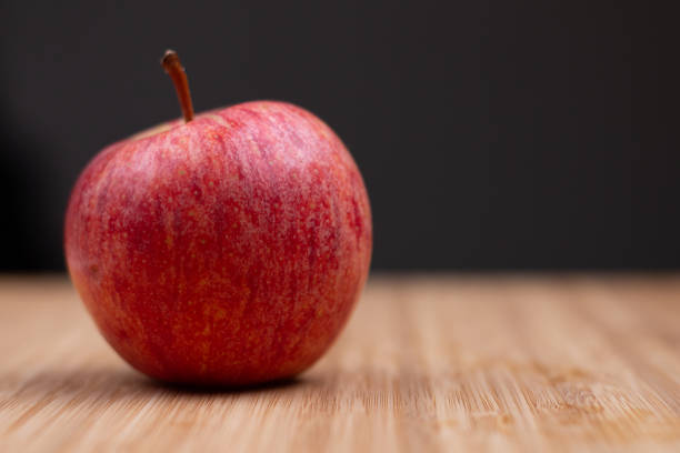 istock One fresh red apple on a wooden background 1270821756
