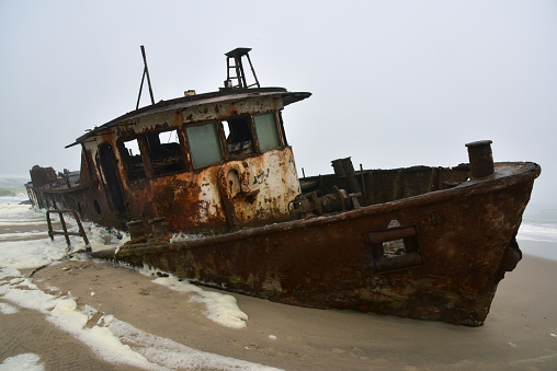 Wreck of the trawler Shawnee that ran aground in 1976 on the beach off the Atlantic Ocean in the Namib Desert