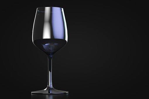 Empty wine glass with highlights on dark background