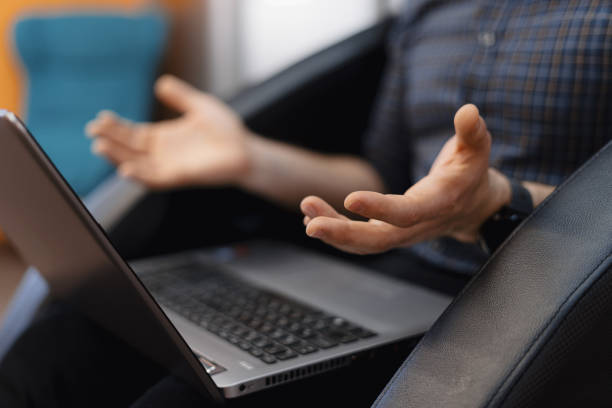 istock Male hands showing confusion with a laptop on the legs 1270825812