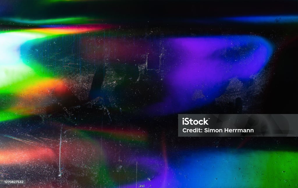 glitter pattern background, real macro photo. silver rainbow holographic foil texture, colorful hologram surface with dust and scratches. Hologram Stock Photo