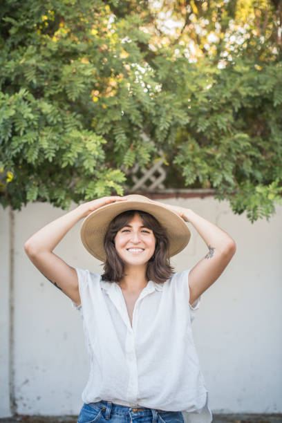 istock Young Mexican Woman With Straw Hat Smiling in Backyard 1270827564