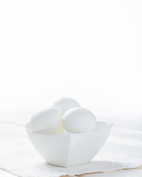 istock white eggs in a bowl on white wooden background 1270830675