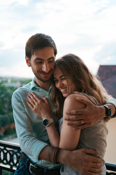 istock Portrait couple hugging on balcony 1270832852