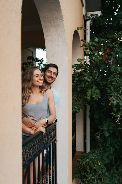 istock Portrait couple hugging on balcony 1270832854