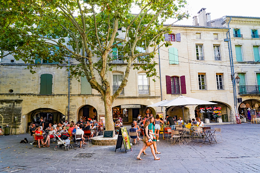 France. Gard (30) The city of Uzes. People walking in The herb square