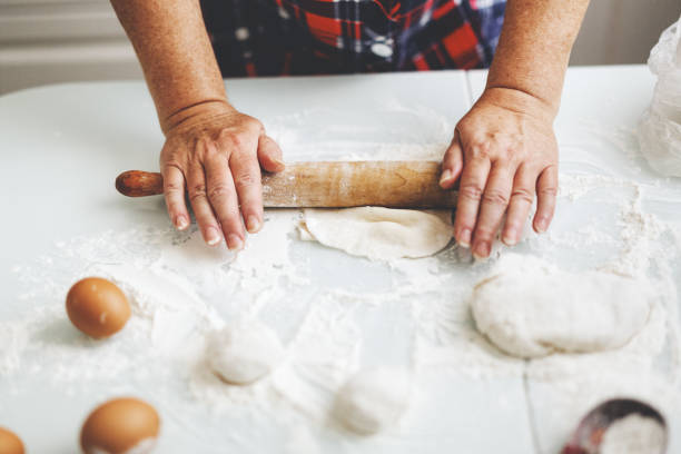 istock Woman at home kneading dough for cooking pasta pizza or bread. 1270837128
