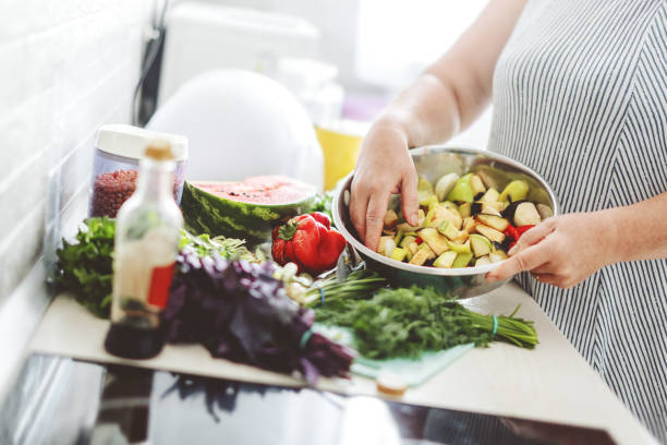 istock Woman cooking vegetables in the kitchen. 1270837142