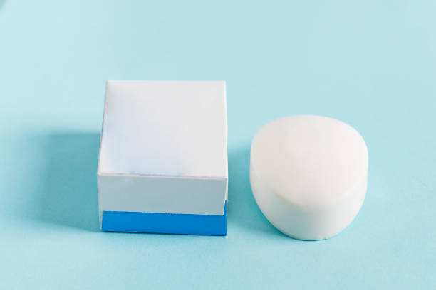 istock Aromatic natural soap bar and blank white paper box for packaging on a pastel blue background. Mock-up for your design and creativity. 1270837390