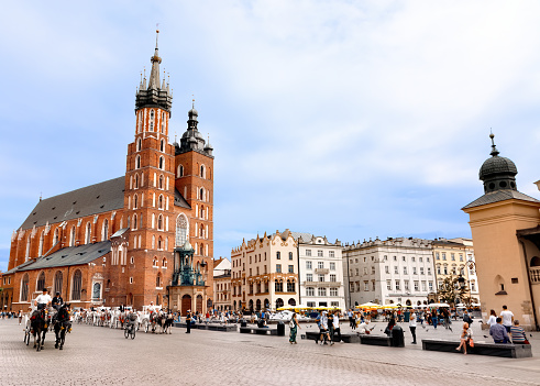 Krakow, Poland - May 22, 2023: People going at Main Market Square in Krakow in a summer day, Poland