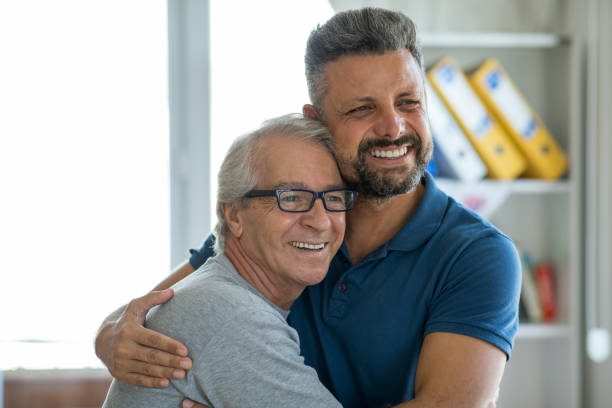 istock Man and his senior father embracing 1270842448