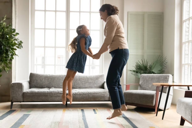 Happy multigenerational family jumping barefoot at home.