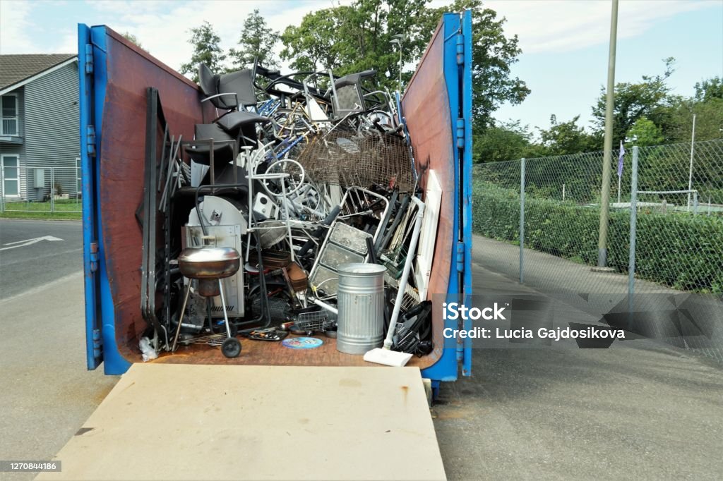 Metal waste collected in a container in a community disposal place. Metal waste collected in a container in a community disposal place. A public service free of charge to prevent littering the environment. Efficient waste management supporting awareness of citizens. Garbage Stock Photo