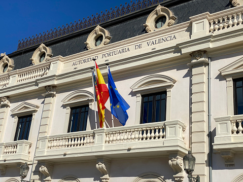 Valencia, Spain - September 5, 2020: Low angle view of main section of the Port Authority building in the port area of the city. It is the public body responsible for running and managing three state-owned ports along an 80 km stretch of the Mediterranean coast in Eastern Spain: Valencia, Sagunt and Gandia