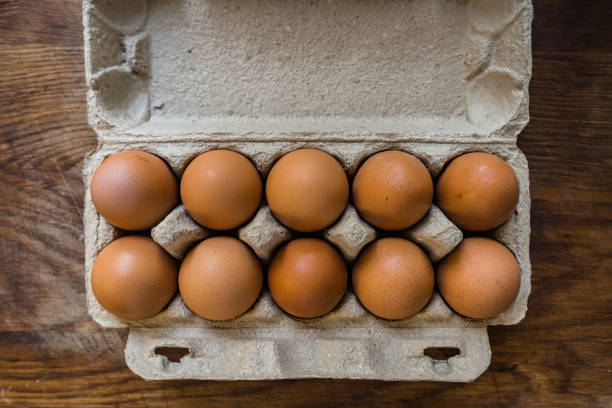 istock Whole, raw eggs in an egg tray on a wooden kitchen table 1270849809
