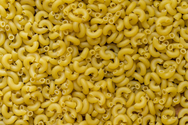 istock Full background of dry uncooked macaroni pasta 1270849923
