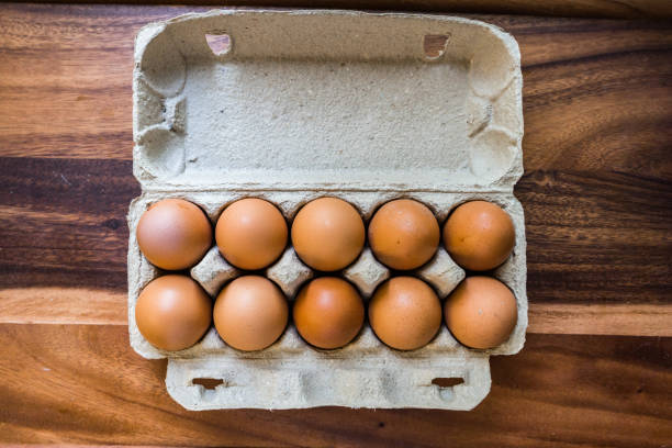 istock Whole, raw eggs in an egg tray on a wooden kitchen table 1270850068