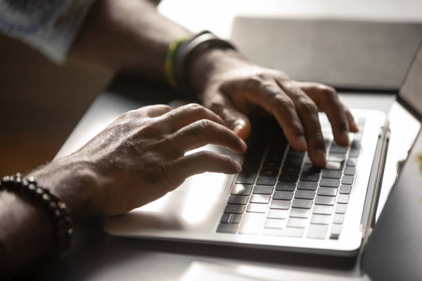 istock Close up African American man typing on laptop keyboard 1270850613