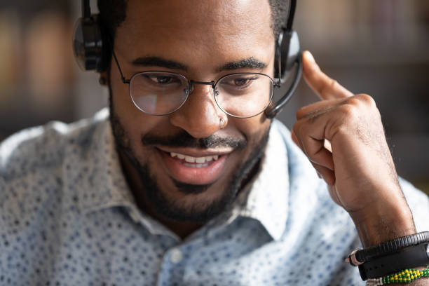 istock Close up friendly African American man wearing headset speaking 1270850621