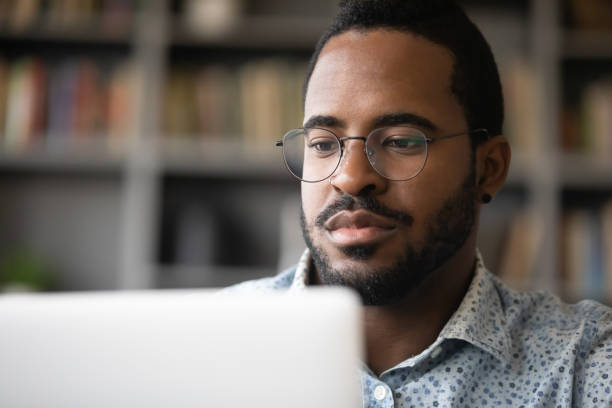 istock Close up serious African American man looking at computer screen 1270851091