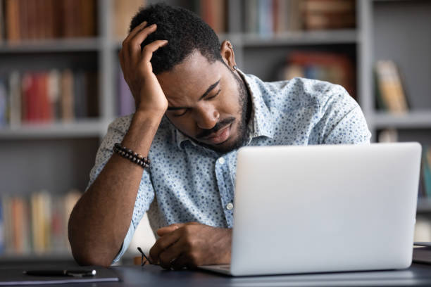 istock Tired African American businessman sleeping, sitting at work desk 1270851157