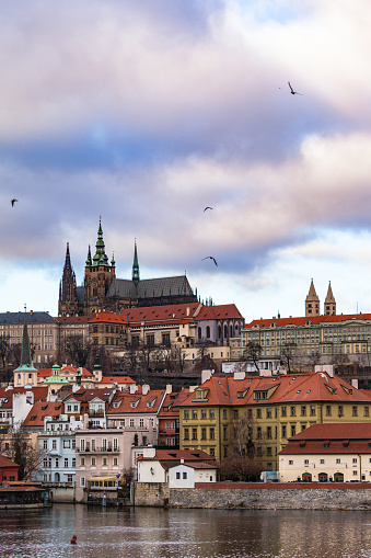 Beautiful view of Prague Castle and St. Vitus Cathedral located in Mala Strana old district on the Vltava river side of Prague on winter day with blue sky cloud,  Czech Republic