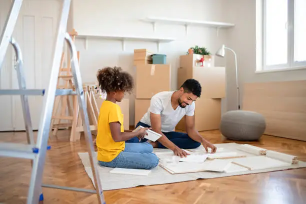 Father and Daughter Assembling Furniture in New Apartment, Moving in and Being Hardworking