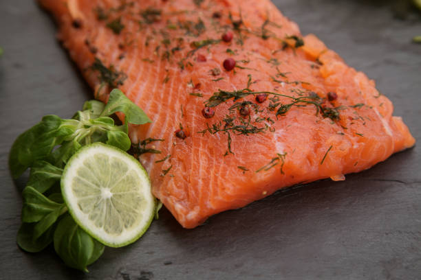 istock a piece of lightly salted salmon on a black background close up. 1270853628