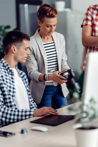 istock Creative team reviewing images on camera in the office 1270854225