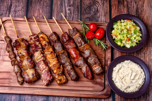 Kebab - Grilled meat on a cutting board, with flour and vinaigrette salad Kebab - Grilled meat on a cutting board, with flour and vinaigrette salad. skewer photos stock pictures, royalty-free photos & images