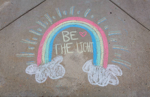 istock Be the light written with sidewalk chalk with a rainbow 1270864240