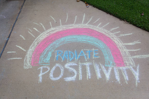 istock Radiate positivity written with sidewalk chalk with a rainbow 1270864274