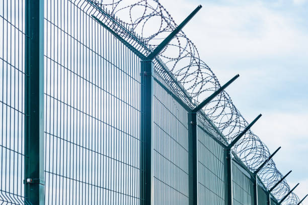 istock Metal fence with barbed wire. 1270865577